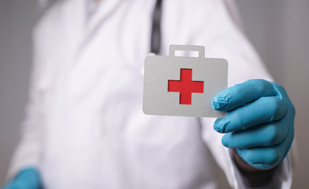 A 3D rendering of a healthcare worker holding a health icon -health insurance conceptの写真素材