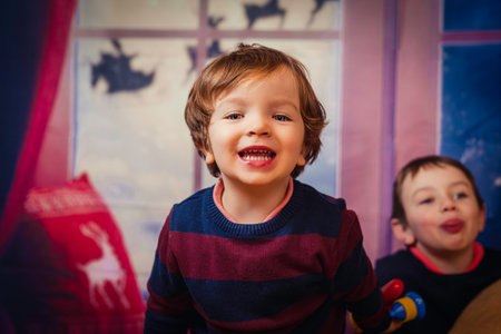 An adorable blond baby boy with a happy face and blue, crystal eyes, Spain