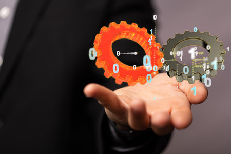 A human hand showing a 3D rendering of abstract digital gearsの写真素材