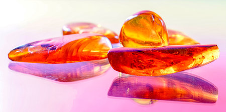 A closeup shot of amber stone, yellow transparent fossil resin with insect inclusionsの写真素材