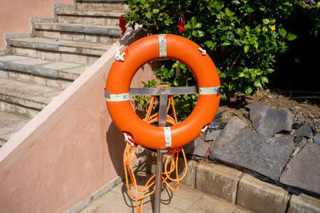 An orange SOS ring hanging in a park