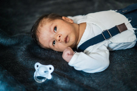 A cute Caucasian newborn baby with a fashionablecostume
