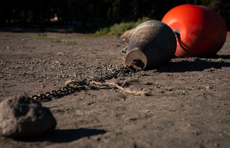 A closeup of old buoys on the ground under the sunlight with a blurry backgroundの写真素材
