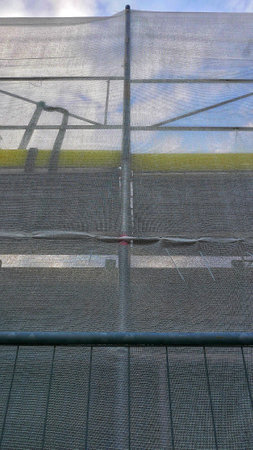 A net green house in the farm against a cloudy skyの写真素材