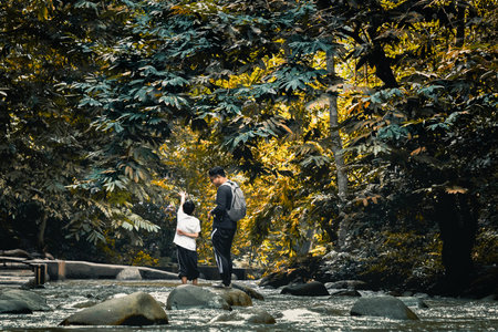 A scenic view of a father and a son traveling in the forestの写真素材