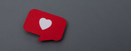 A red heart symbol on a grey background, valentine loveの写真素材