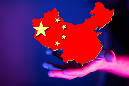 A 3d illustration of the map of China floating near a handの写真素材