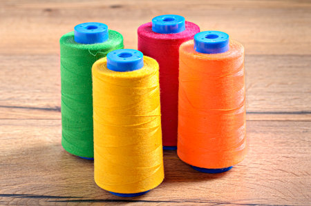 The rolls of colorful thread on a wooden table