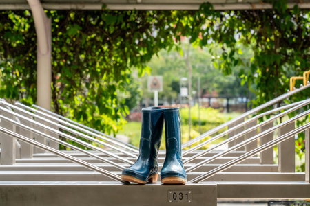 Galoshes, rubber garden boots drying under the sun. Horizontal shot with copy spaceの写真素材