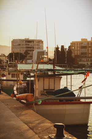 A boat moored in the harbor on the sunsetの写真素材