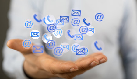 A hand showing email icon on screen - concept of business communicationの写真素材