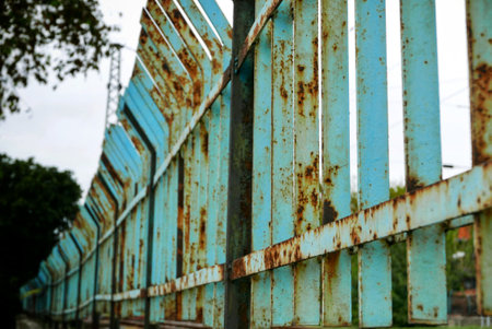 An old and rusty metal fenceの写真素材