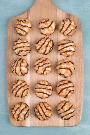 Coconut macaroons on a textured blue background, sweets christmas timeの写真素材
