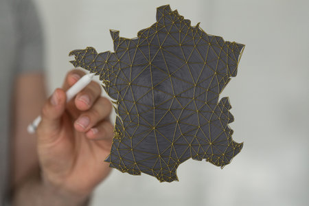 A 3D illustration of the map of France in front of a person with a pencilの写真素材