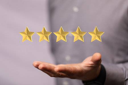 The 3D rendered star icons with a male's hand in the backgroundの写真素材