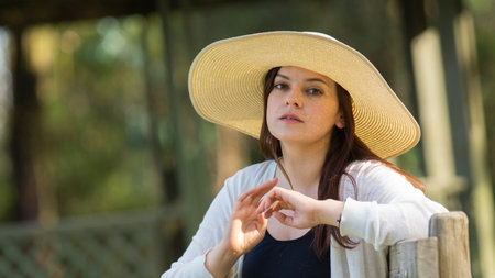 A closeup of a young Ecuadorian female wearing a sombrero
