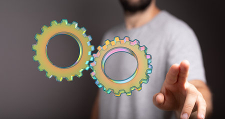 A person presenting 3D rendering of digital gearsの写真素材