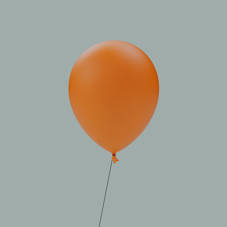 An orange Halloween balloon isolated on a gray backgroundの写真素材
