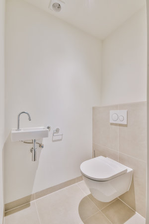 A vertical shot of a bathroom with white tiles on the walls