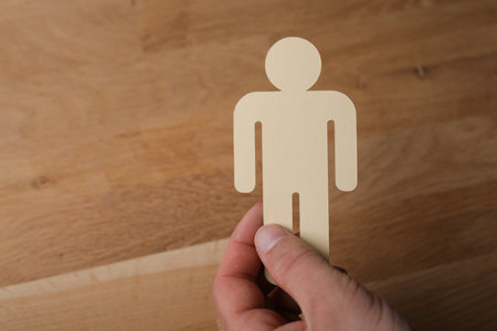 A man holding a person symbol, job recruitmentの写真素材