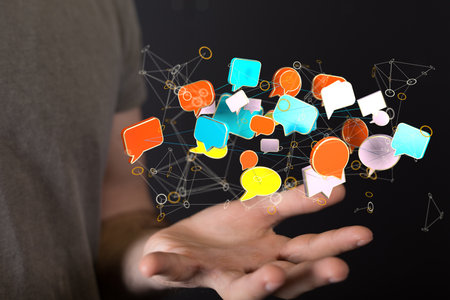 An abstract shot of a man's hand showing 3D rendered digital email and message icons on the webの写真素材