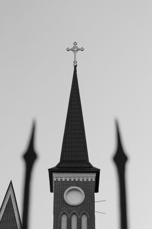 A closeup shot of the view of the cross on the top of church with blurry backgroundの写真素材
