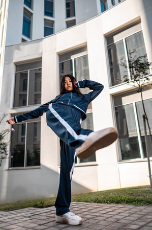 An attractive Asian woman in sportswear posing in the streetの写真素材