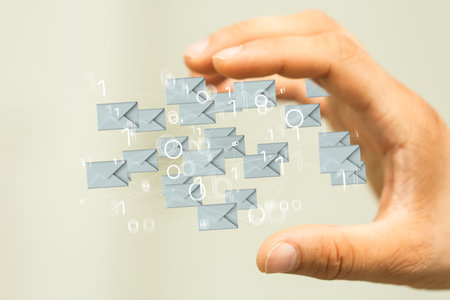 A hand showing email icon on screen - concept of business communicationの写真素材