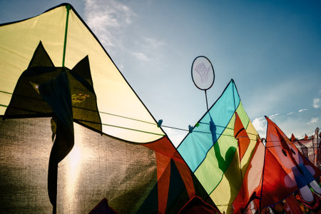 A shot of colorful tents reflecting different shadows on a sunny day with the sky backgroundの写真素材