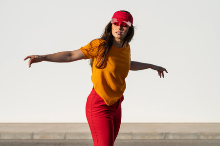 A stylish Caucasian female in a bright outfit posing outsideの写真素材