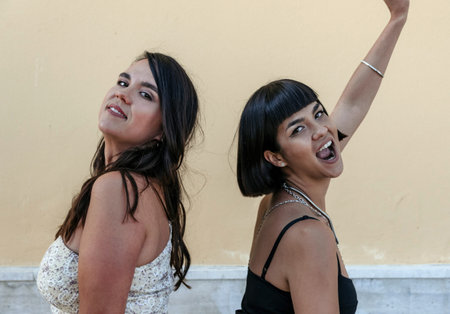 Portrait of two stylish young women. Sisters posing for photo.の写真素材