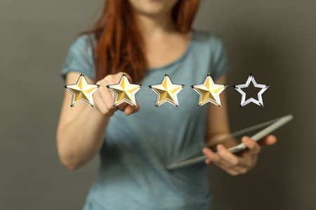 A female's hand pointing to illustrated review stars