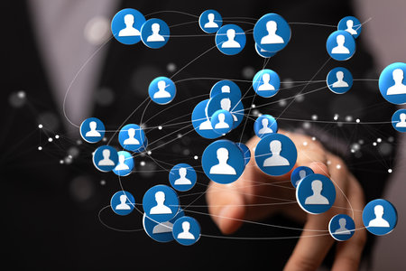 A 3D rendering of a group of floating people icons on a businessman's handの写真素材