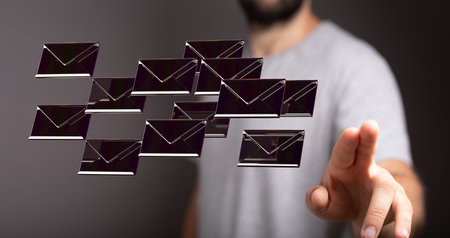 A male's hand pointing to illustrated email iconsの写真素材