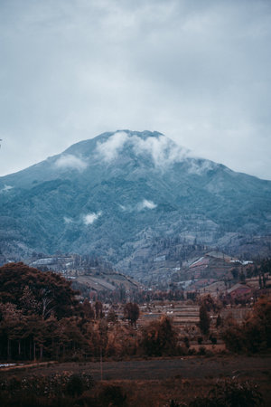 A beautiful landscape of a high mountain with a village on the slopeの写真素材