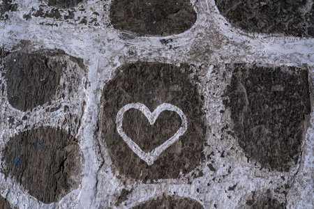 A cute white heart on the cobblestoneの写真素材