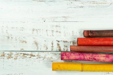 A shot of colorful bamboos on a white plank backgroundの写真素材