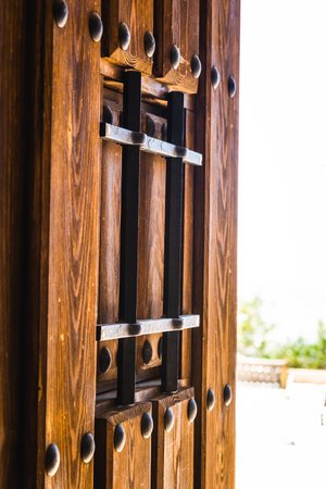 A vertical shot of an open wooden door