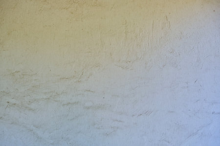 A close-up shot of a white grunge plaster stucco concrete wall texture for backgroundの写真素材
