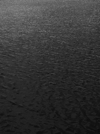 black sea water texture. water reflection texture background. Dark background, High resolution background of dark water or oil surface. Ocean surfaceの写真素材