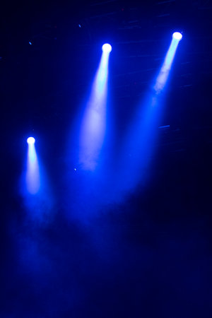 Play of lights on stage in a large mass concert before Covid 19 in Latin America. Stage lighting effect in the darkの写真素材