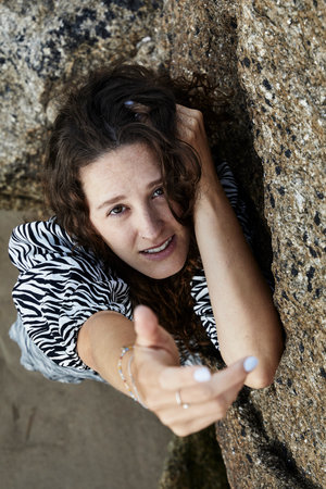 A vertical shot of a Caucasian attractive woman on a beach in Spainの写真素材