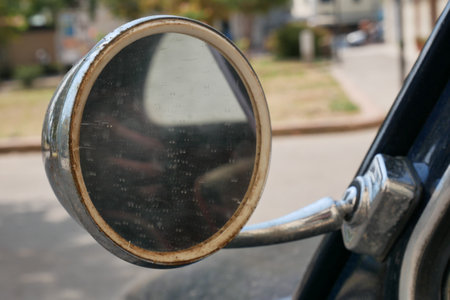 A closeup shot of a side mirror of a car on a blurred backgroundの写真素材