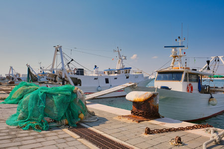 View of the typical fishing boats and fishing nets in the port of Manfredonia in the Apulia region in southern Italyの写真素材
