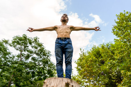A young Spanish man with arms wide open; freedom conceptの写真素材