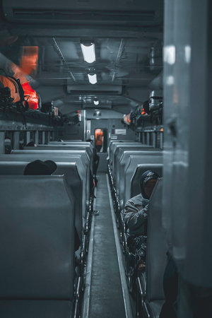A vertical shot of a narrow train passageway between seatsの写真素材
