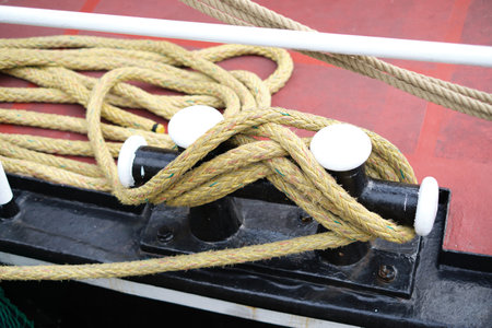 Close up of a secured and coiled up rope on a metal sailing ship. Sailing sports at the North Sea...