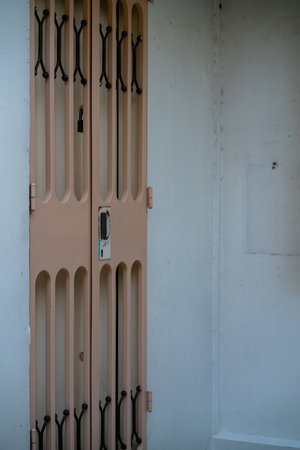 Door and metal gate at HDB in Singapore. Vertical shot