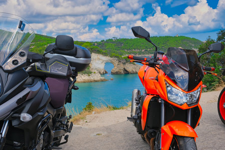 parked motorbikes on a mountain road in the Gargano Mountains in southern Italy with a great view of the bays in the seaの写真素材