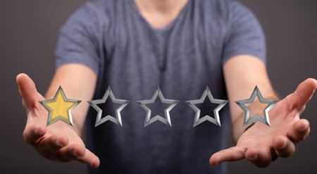 A person presenting 3D render of rating starsの写真素材
